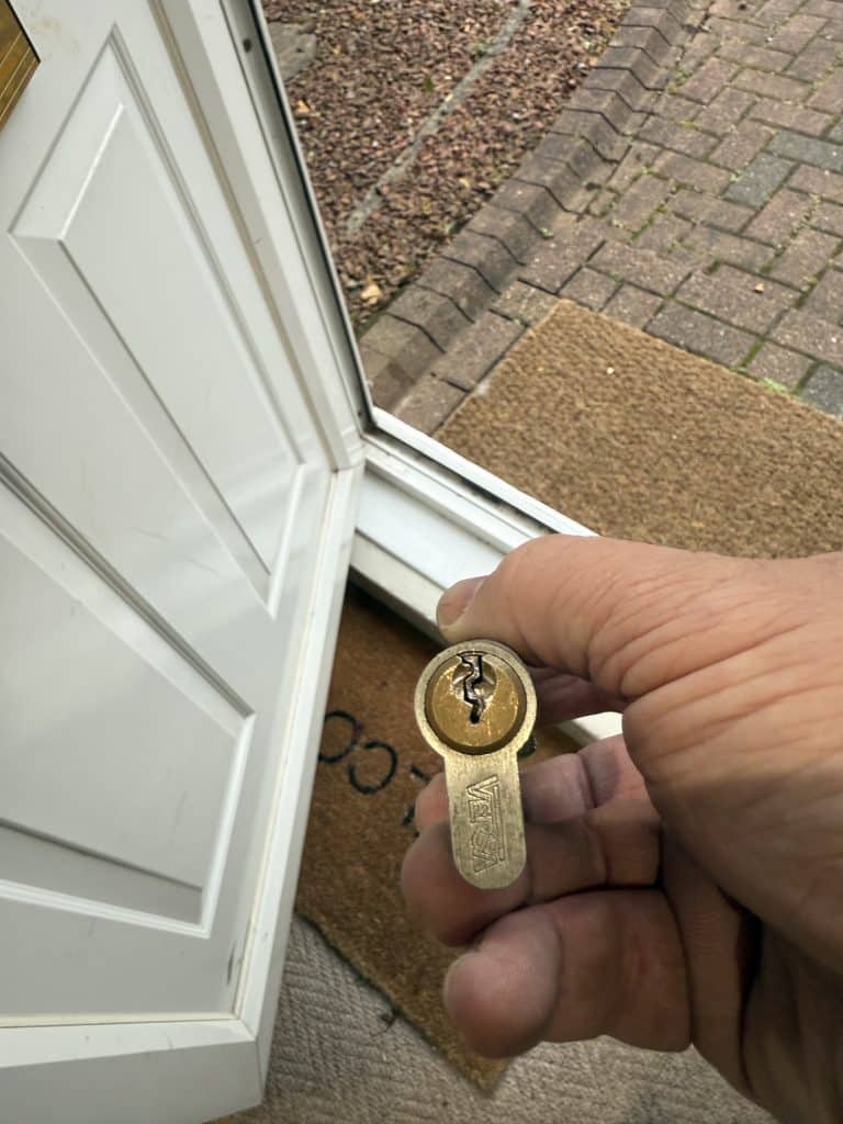 Broken VERSA euro cylinder lock removed from a uPVC door after key snapped inside — photographed during emergency locksmith callout in Gateshead.